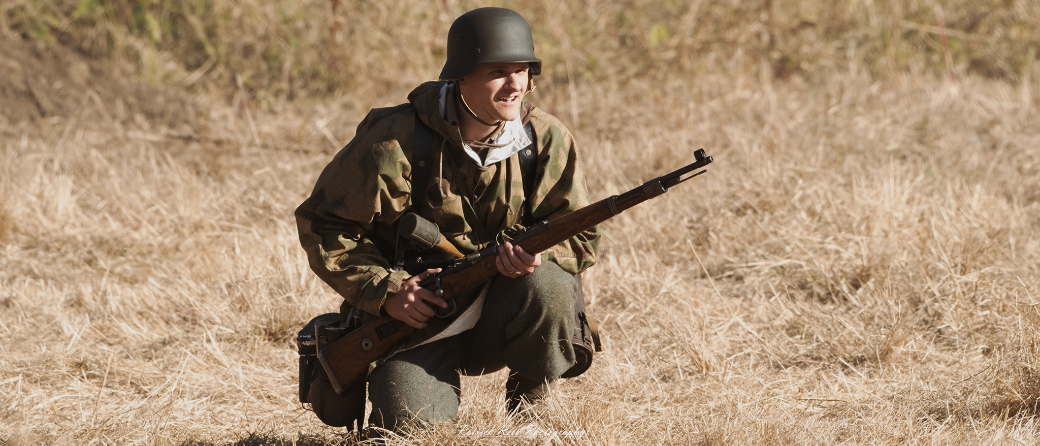 "U.S. GI soldier in a grassy field during World War II, showcasing the rugged determination of American troops. The soldier is in full military gear, including a helmet and fatigues, holding a rifle while surveying the surroundings. The background depicts a landscape of rolling hills or trees, reflecting the natural environment where battles took place. This image captures the essence of bravery and readiness, symbolizing the sacrifices made by soldiers in the pursuit of freedom."